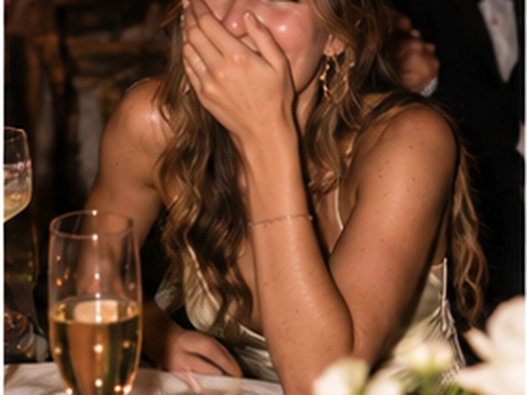 A guest hiding her face, laughing