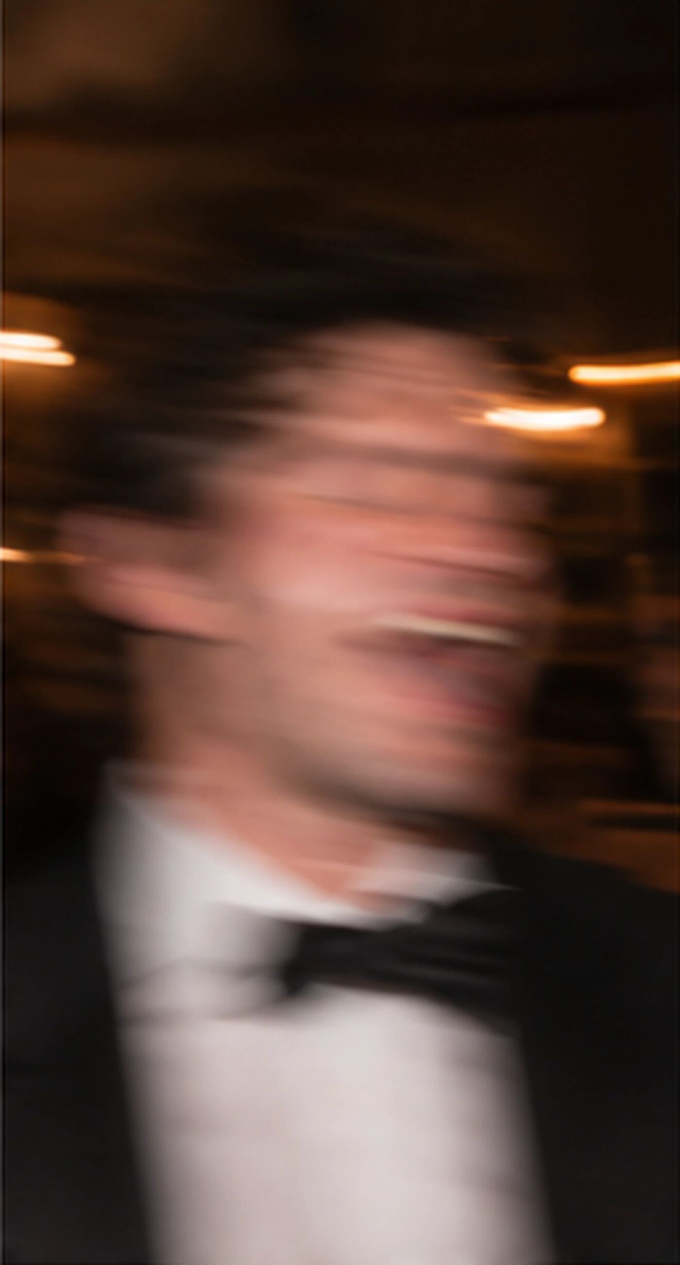 A motion-blurred man in a bow tie