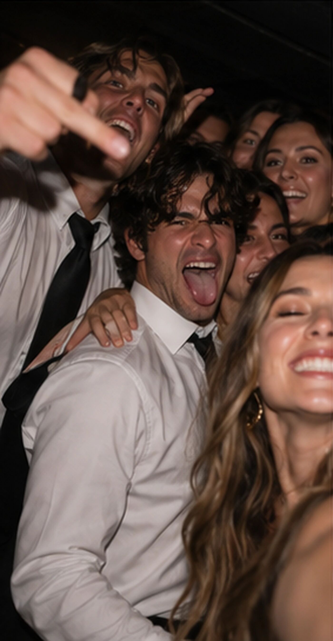 Friends piled together, one pulling a face