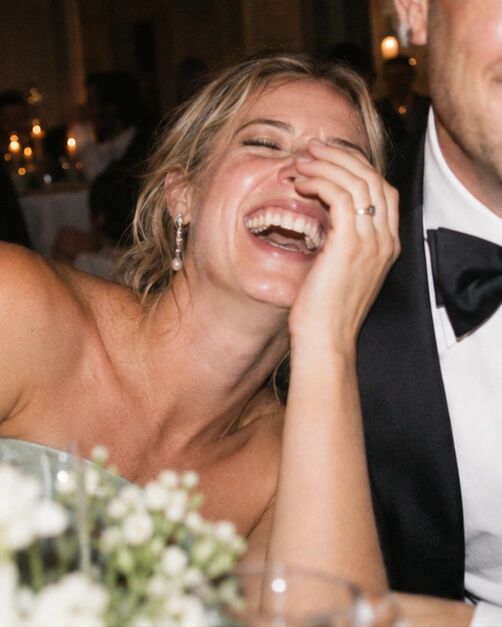 A guest laughing so hard her eyes are shut, badly framed and perfect