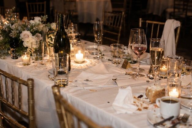 A candlelit long table, half-eaten and abandoned