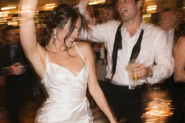 A bride mid-spin on a blurred dancefloor