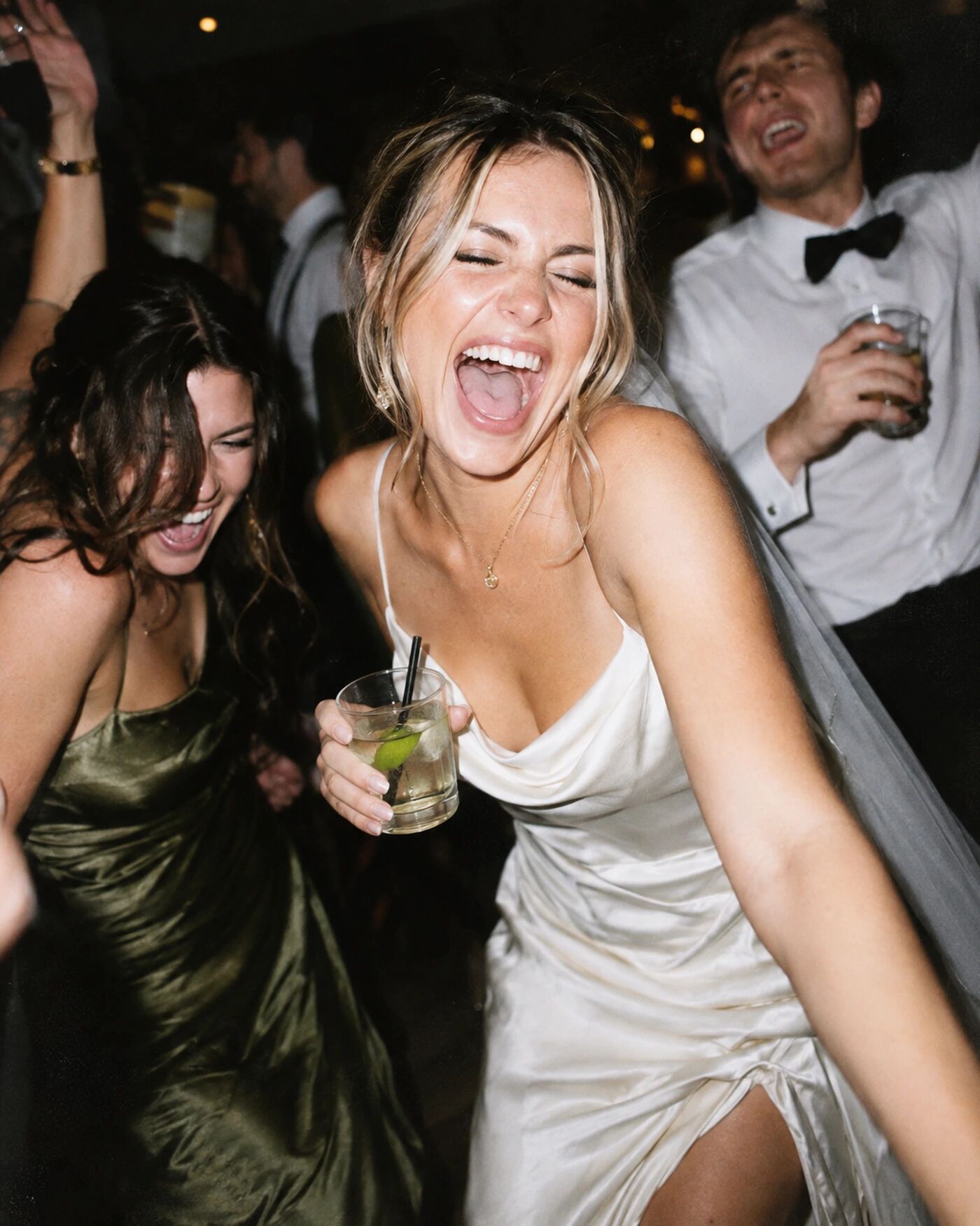 A bride shouting with joy on the dancefloor