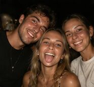 Three friends grinning in a night selfie