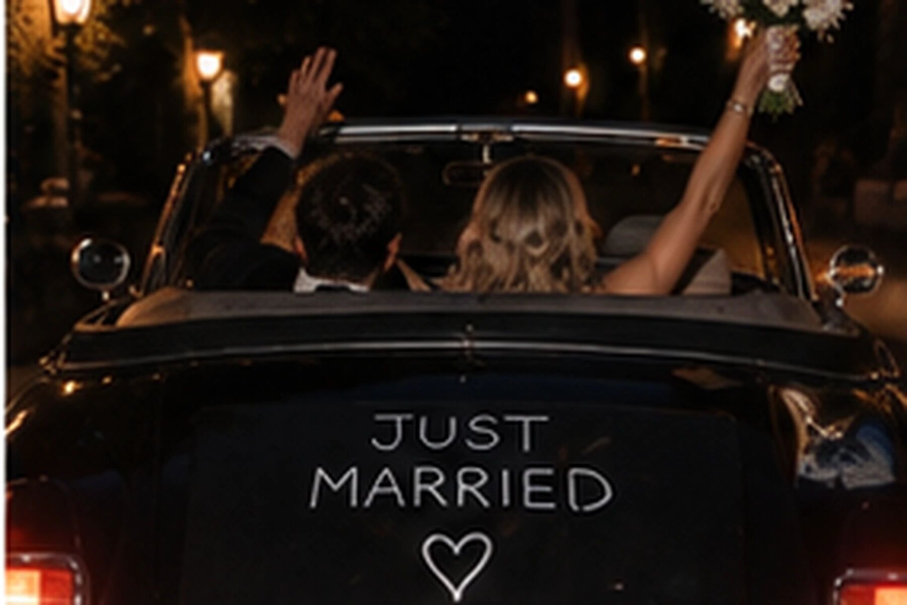 A couple leaving in a convertible, arms up